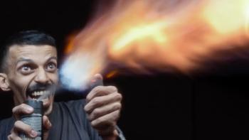 Naga movie: Saudi man on left sprays aerosol can into a lighter flame creating a small flame thrower