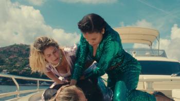 Nice Girls movie: White French woman left, Black French woman center, together pin a culprit to the ground on top of yacht