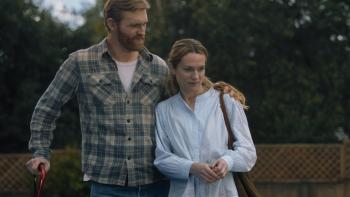 Night Swim Movie: Ray Waller, leaning on a red cane, wraps his arm around his wife, Eve, looking confident and hopeful