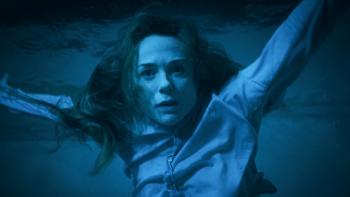 Night Swim Movie: Eve (Kerry Condon), floating underwater and bathed in a blue light, looks deeply concerned, even terrified