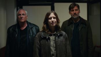 Nightwatch: Demons Are Forever movie: Danish white woman, two white men in jackets left and right, all stand in hallway