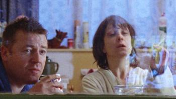 Nil by Mouth: Ray Winstone and Kathy Burke seen through a window