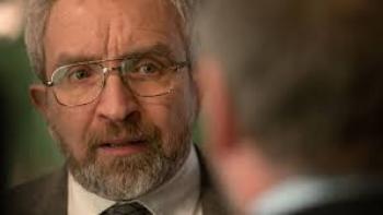 No Ordinary Heist: Elderly man with glasses and beard in a suit, looking serious