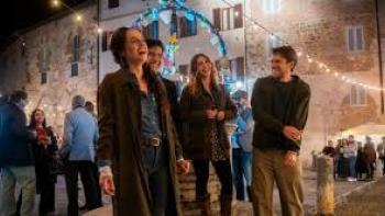 No Place to Be Single: Group of friends laughing at a night street festival.