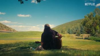 Noah Kahan: Out of Body: With guitar outdoors.