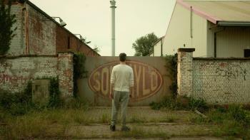 Noise: Mattias faces the factory door. 