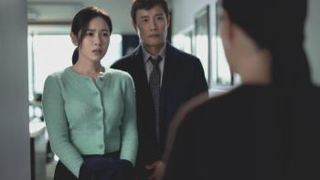 No Other Choice Movie: Visibly shocked, Mi-ri and Man-su speak with their daughter's cello teacher, whose back is to viewers