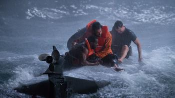 Not Without Hope movie: Zachary Levi holds onto Quentin Plair as he sits on top of a capsized boat