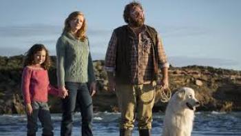 Oddball: Family walks on beach with white dog