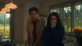 Oh, Hi! movie: Geraldine Viswanathan covers her mouth in shock next to John Reynolds as they look at something, stunned