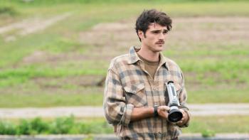 Oh, Canada Movie: Young Leonard Fife (Jacob Elordi) holds a camera near a field, looking deeply thoughtful