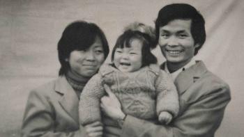 One Child Nation Movie: In a vintage black and white photograph, a mother and father hold their baby, smiling ecstatically