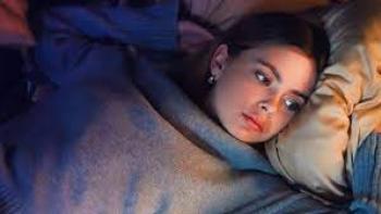 One Night Stand: Indonesian woman in sweater center lies on bed looking wistfully