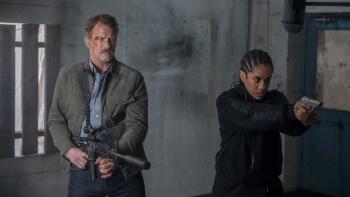 One Ranger Movie: Texas Ranger Alex Tyree (Thomas Jane) and British Intelligence Agent Jennifer Smith (Dominique Tipper) point their guns at something threatening