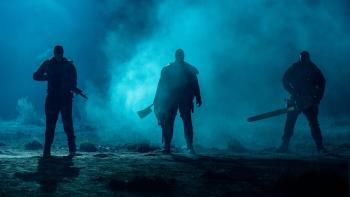 Onslaught Movie: Three sinister silhouettes stand against the fog at night, each holding a weapon