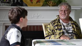 Operation Friendship: A boy looks at an older man with drawing on his face