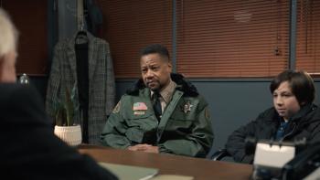 Dog Patrol: Operation Santa Paws movie: Cuba Gooding Jr playing an officer sits at a table next to a child