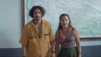 Oregon movie scene 2: A  man and woman stand in front of a map