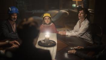 Other Mommy movie: Daddo (Jay Duplass), Bela (Arabella Olivia Clark), and Mommy (Jessica Chastain) sit around a table in hard hats during a seance