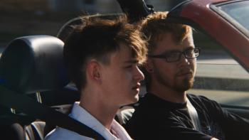 Our Hero, Balthazar movie: Asa Butterfield drives a car, looking over at Jaeden Martell in the passenger seat