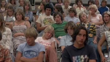 Over the Edge: A roomful of kids sitting on folding chairs look bored