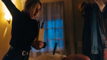 Over Your Dead Body movie: Samara Weaving holds knives in a dimly lit room, expressing anger