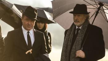 Blackbird: Characters dressed in black suits and ties attend a funeral