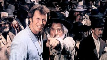 Paint Your Wagon: A tall man in a blue shirt stands with a man with long white hair who is pointing his finger
