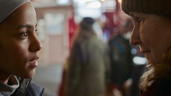 Passenger Movie: A concerned Maddie speaks with Diane at a get-together for van travelers