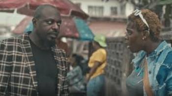 Passport: Nigerian man on left faces Nigerian woman with white sunglasses in hair on right