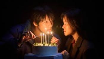 Pavane Movie: Asian young man and woman light birthday candles