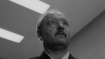 The Pawnbroker: Rod Steiger looks up toward the ceiling, florescent strip lights above him
