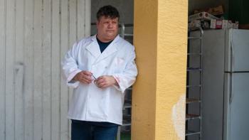 Pet Investigators: A man in a white jacket leans against a yellow banister