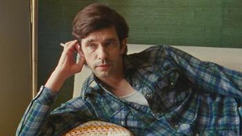 Peter Hujar's Day movie: Ben Whishaw sits on a couch, cigarette in hand