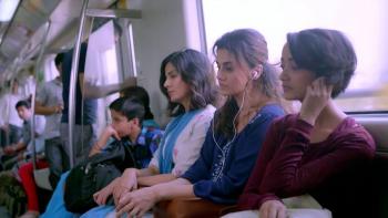 Pink: Three young Indian women sit next to each other on a train