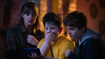 Pinocchio Unstrung Movie: Mia, Dudley, and James react to something shocking they see on a smartphone