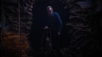 Pinocchio Unstrung Movie: Grandpa Geppetto emerges from a creepy-looking cave holding a wooden puppet