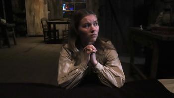 Place of Bones Movie: Teen Hester (Brielle Robillard) kneels by her bedside to pray but looks sideways, deep in thought