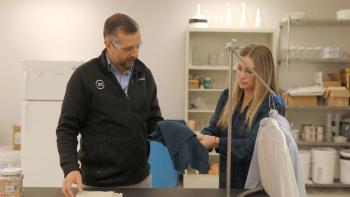 Plastic Earth Movie: The president of Circ, Peter Majeranowski (left), shows filmmaker Janice Overbeck (right) a piece of fabric