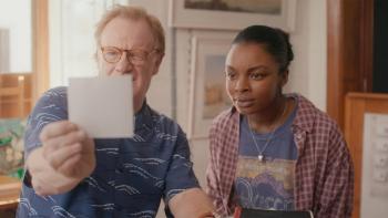 Portraits of Dangerous Women: Man and woman intently examining a photo together indoors