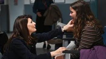 Poisoned Love: The Stacey Castor Story: Nia Vardalos comforts a seated girl in a waiting area.