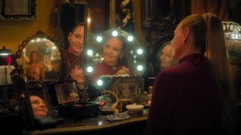 Pretty Lethal: Uma Thurman sits in front of a lit dressing room mirror doing her makeup
