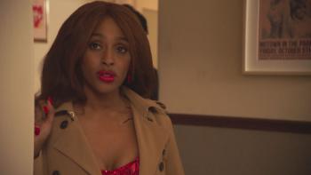 Pretty Red Dress: Alexandra Burke looks unsure as she stands in a doorway, her hair and make-up done