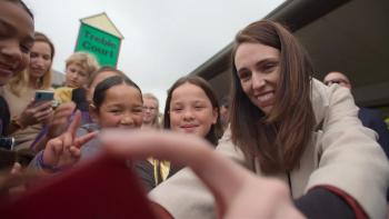 Prime Minister movie: Jacinda Ardern meets supporters outside, many of them children, smiling and waving