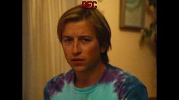 Primetime Movie: In a tie-dye shirt, Dan Plumb (Skyler Gisondo) is on camera looking uncomfortable