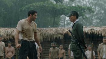 Prisoner of War: A White man and a Japanese soldier face off against each other while standing in the rain