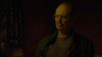 Steve Buscemi sits in the darkness