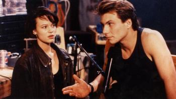 ump Up the Volume: Christian Slater talks into a microphone as Samantha Mathis looks on