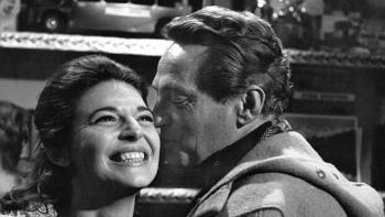 The Pumpkin Eater: Peter Finch kisses Anne Bancroft on the cheek as they both smile