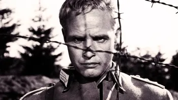 The Young Lions: Marlon Brando peering through barbed wire